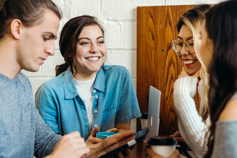 A group of people laughing around a table