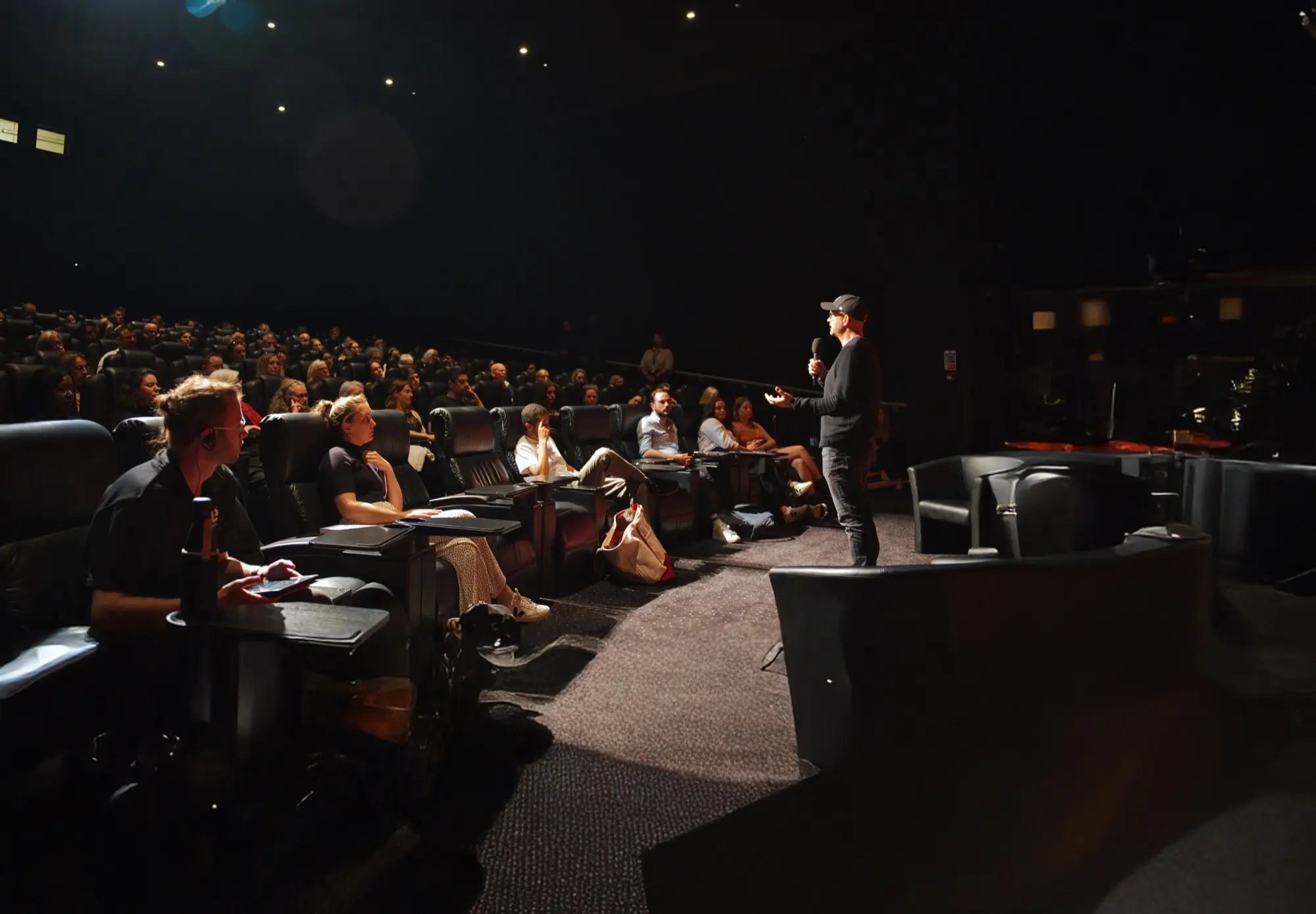 Benjamin Nolot speaks to a crowd in a theatre before a screening of one of Exodus Cry's recent documentaries.